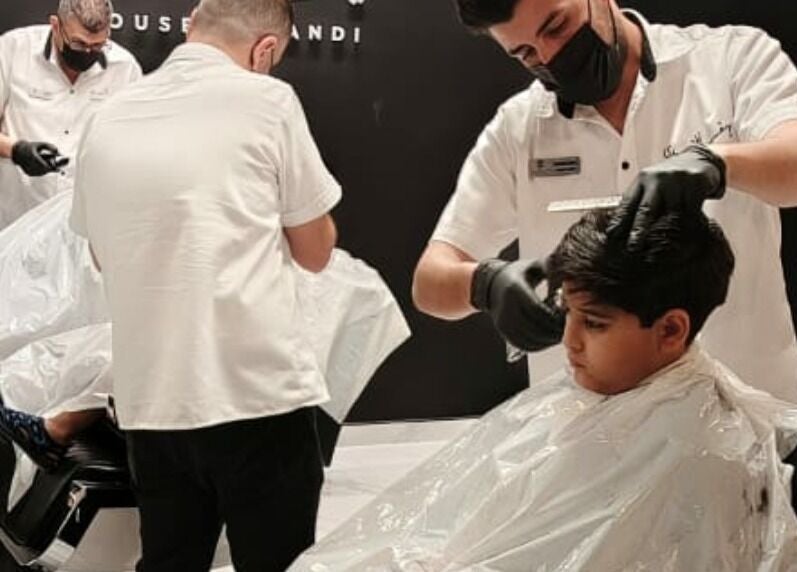 Barbers styling hair at Yousef Afandi Barbershop - Al Sahafa, Riyadh, Riyadh Province, SA.