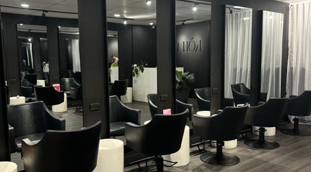 Interior view of Koha The Salon CORINDA, showcasing stylish black chairs in Corinda, Queensland, AU.