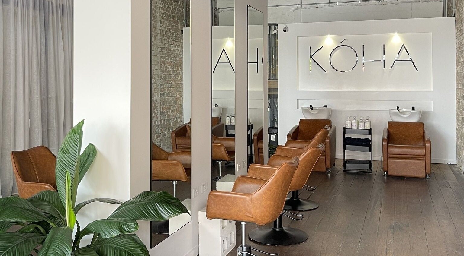 Kòha The Salon DAISY HILL, a stylish salon in Daisy Hill, Queensland, AU with modern decor and leather chairs.
