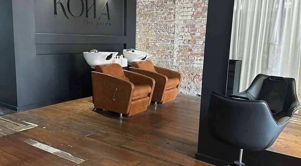 Stylish washing stations at Kòha The Salon DAISY HILL, Daisy Hill, Queensland, AU with exposed brick wall.