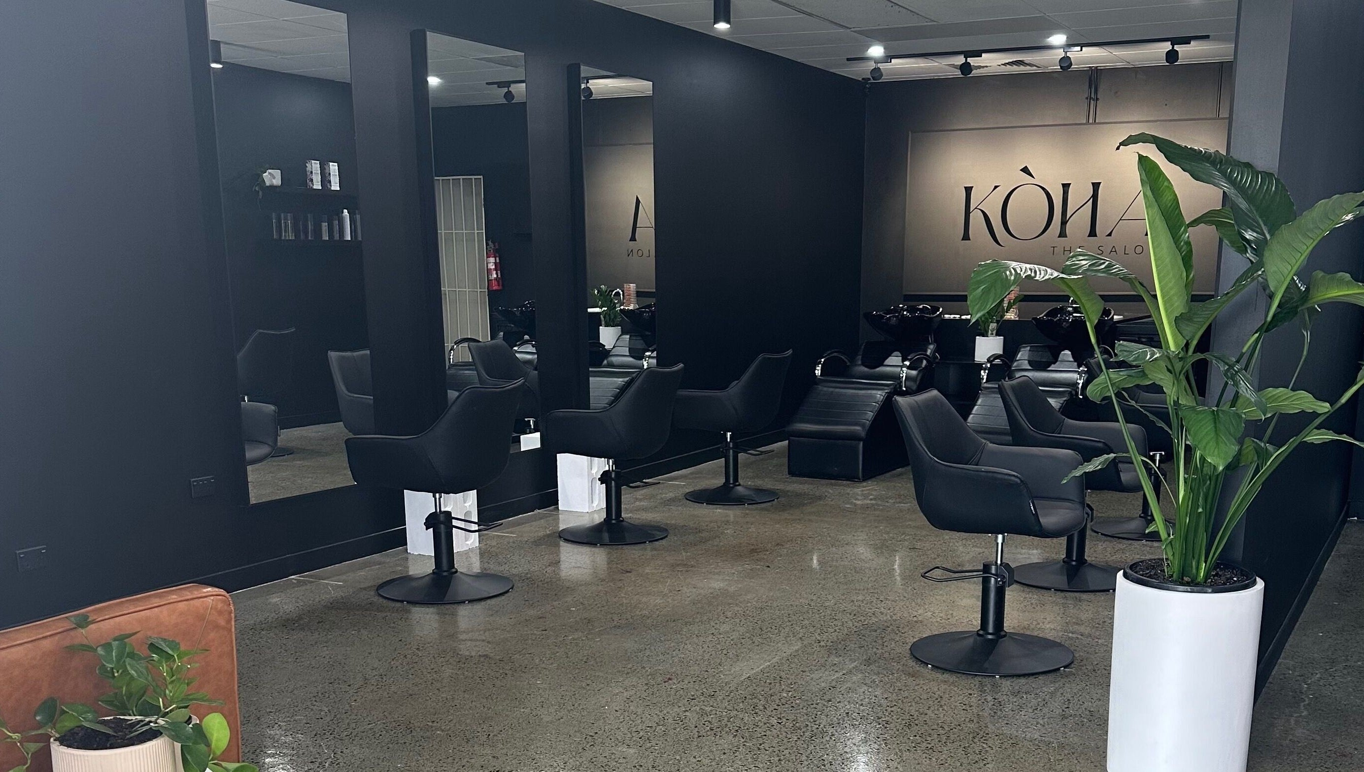 Modern interior of Koha The Salon SPRINGFIELD, featuring stylish black chairs in Springfield, Queensland, AU.
