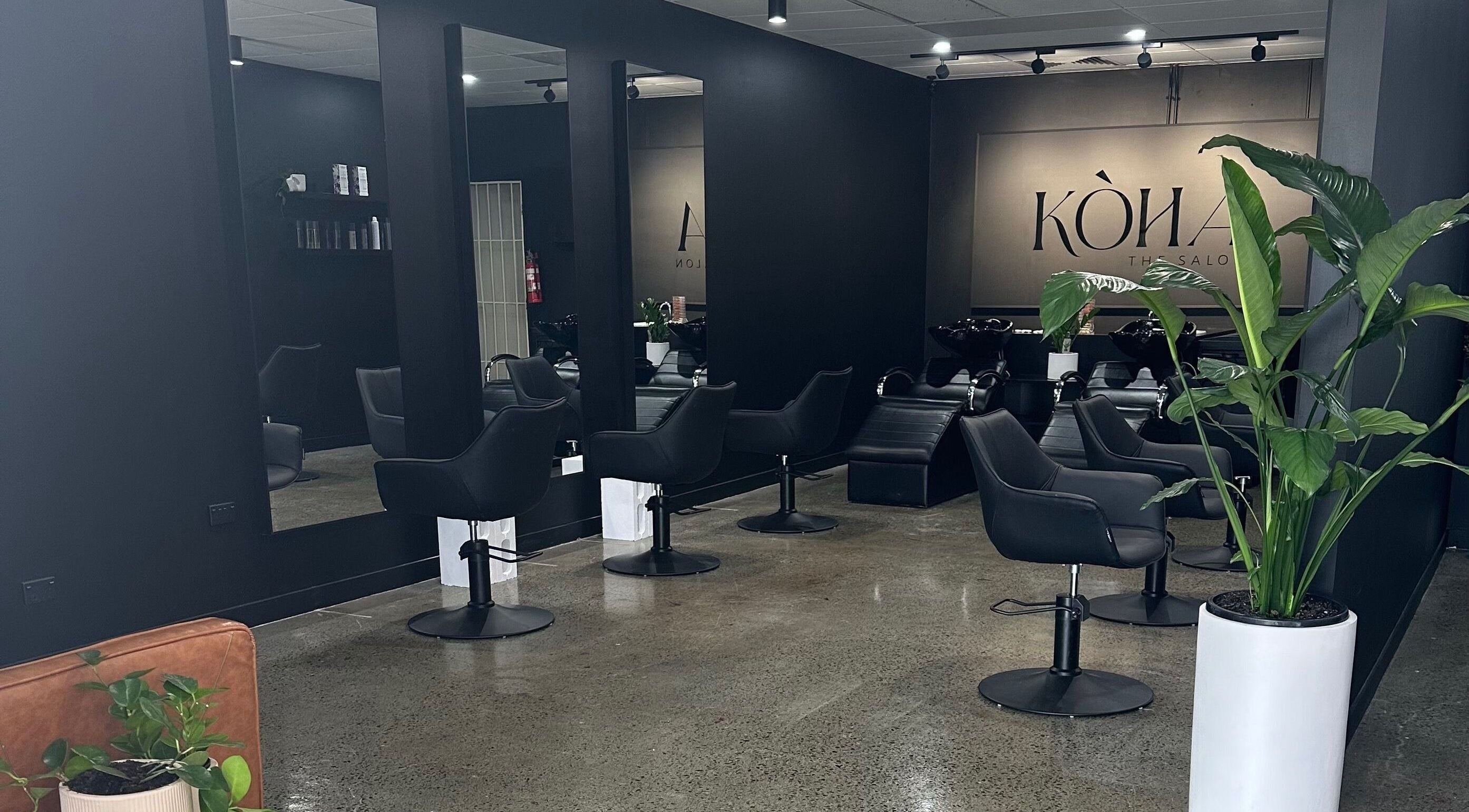 Modern interior of Koha The Salon SPRINGFIELD, featuring stylish black chairs in Springfield, Queensland, AU.