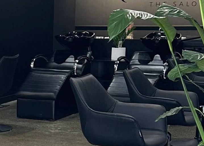 Modern salon interior with sleek black chairs at Koha The Salon SPRINGFIELD, Springfield, Queensland, AU.
