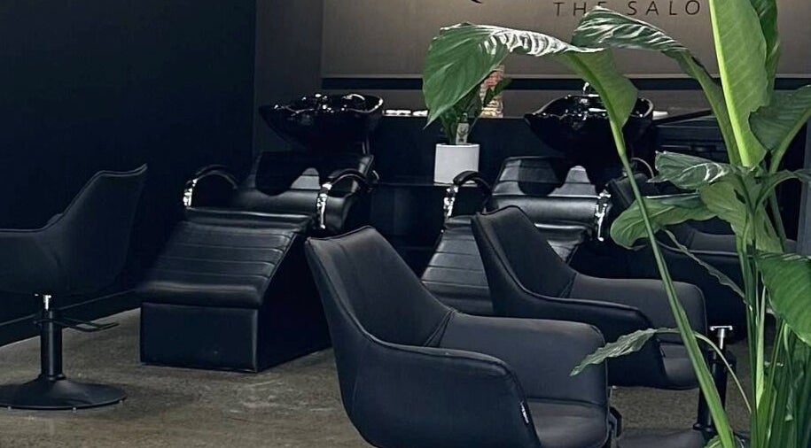 Modern salon interior with sleek black chairs at Koha The Salon SPRINGFIELD, Springfield, Queensland, AU.