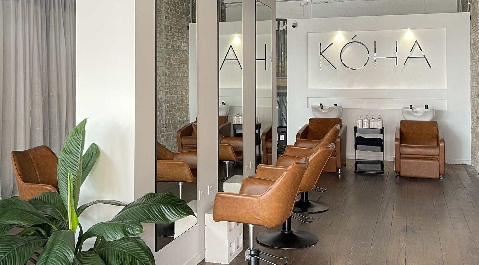 Koha The Salon IPSWICH features chic brown chairs and modern decor in Ipswich, Queensland, AU.