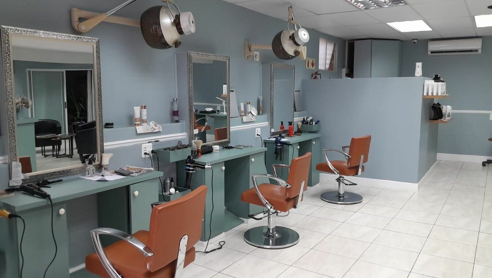 Elegant salon interior at Tippin's in Makhanda, Eastern Cape, ZA featuring stylish chairs and workstations.