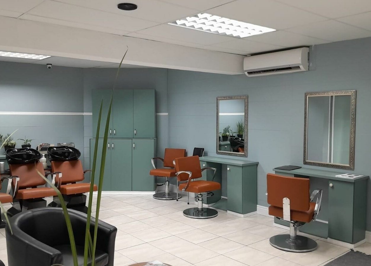 Modern salon interior with styling chairs at Tippin's, Makhanda, Eastern Cape, ZA.