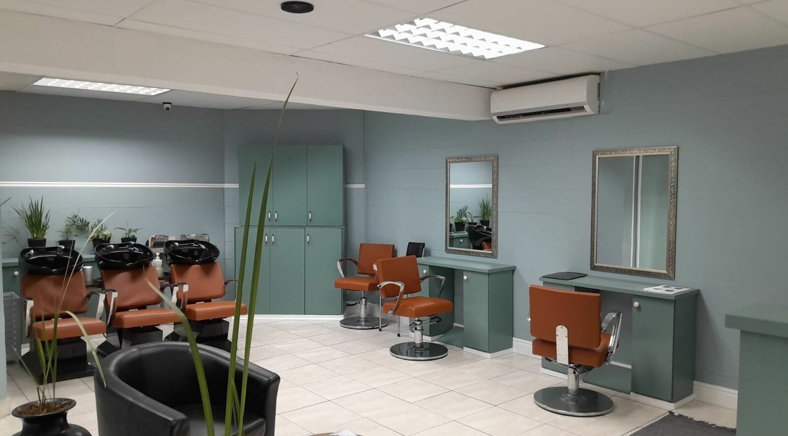 Modern salon interior with styling chairs at Tippin's, Makhanda, Eastern Cape, ZA.