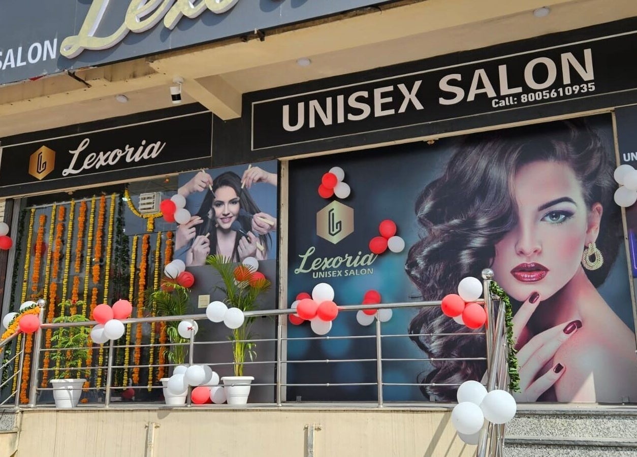Front view of Lexoria Salon in Jaipur, Rajasthan, IN, decorated with balloons and vibrant posters.