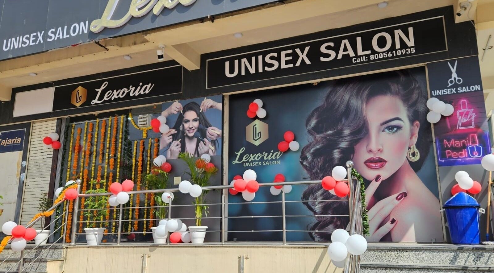 Front view of Lexoria Salon in Jaipur, Rajasthan, IN, decorated with balloons and vibrant posters.