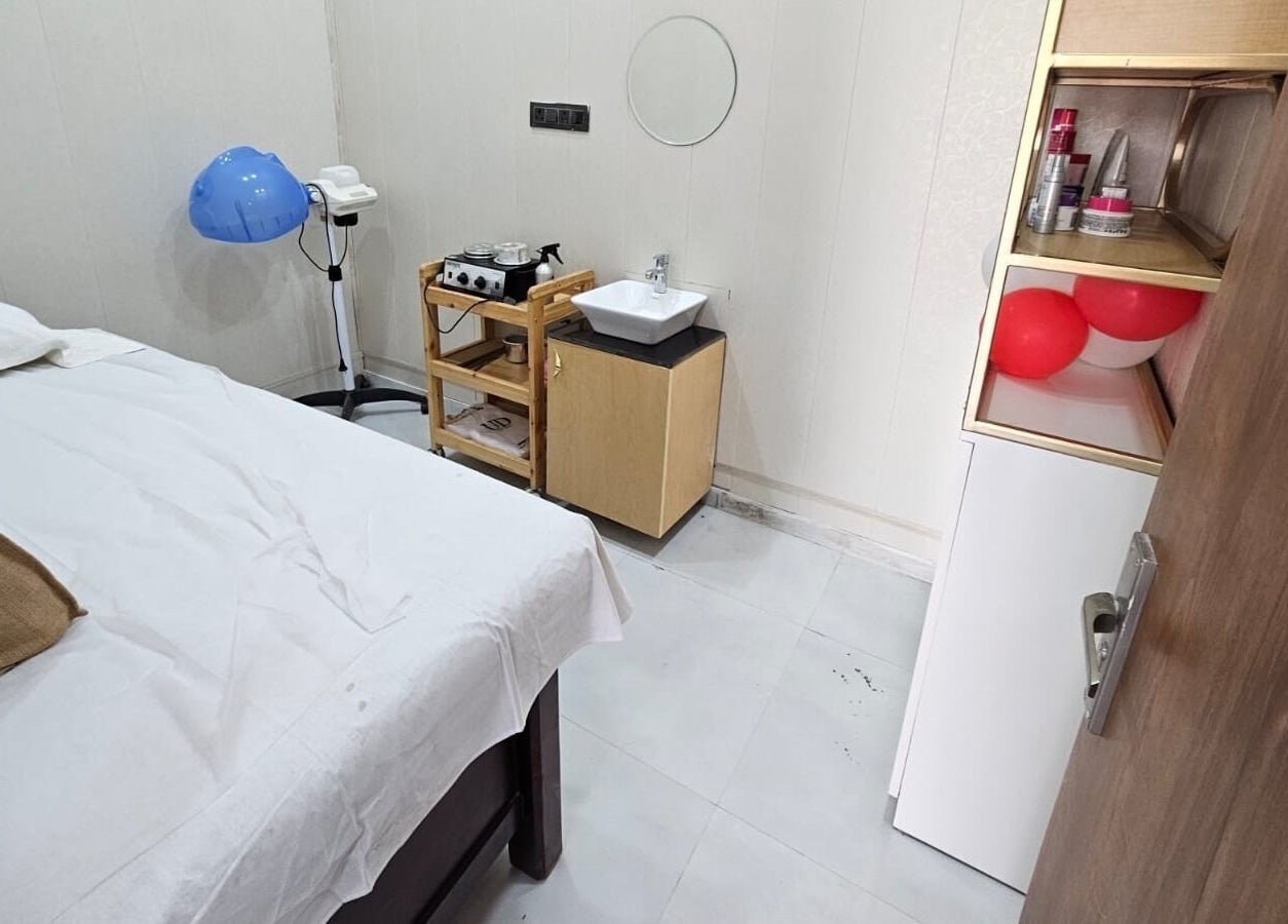 A tranquil massage room at Lexoria Salon, Jaipur, Rajasthan, IN, featuring a cozy bed and aesthetic decor.