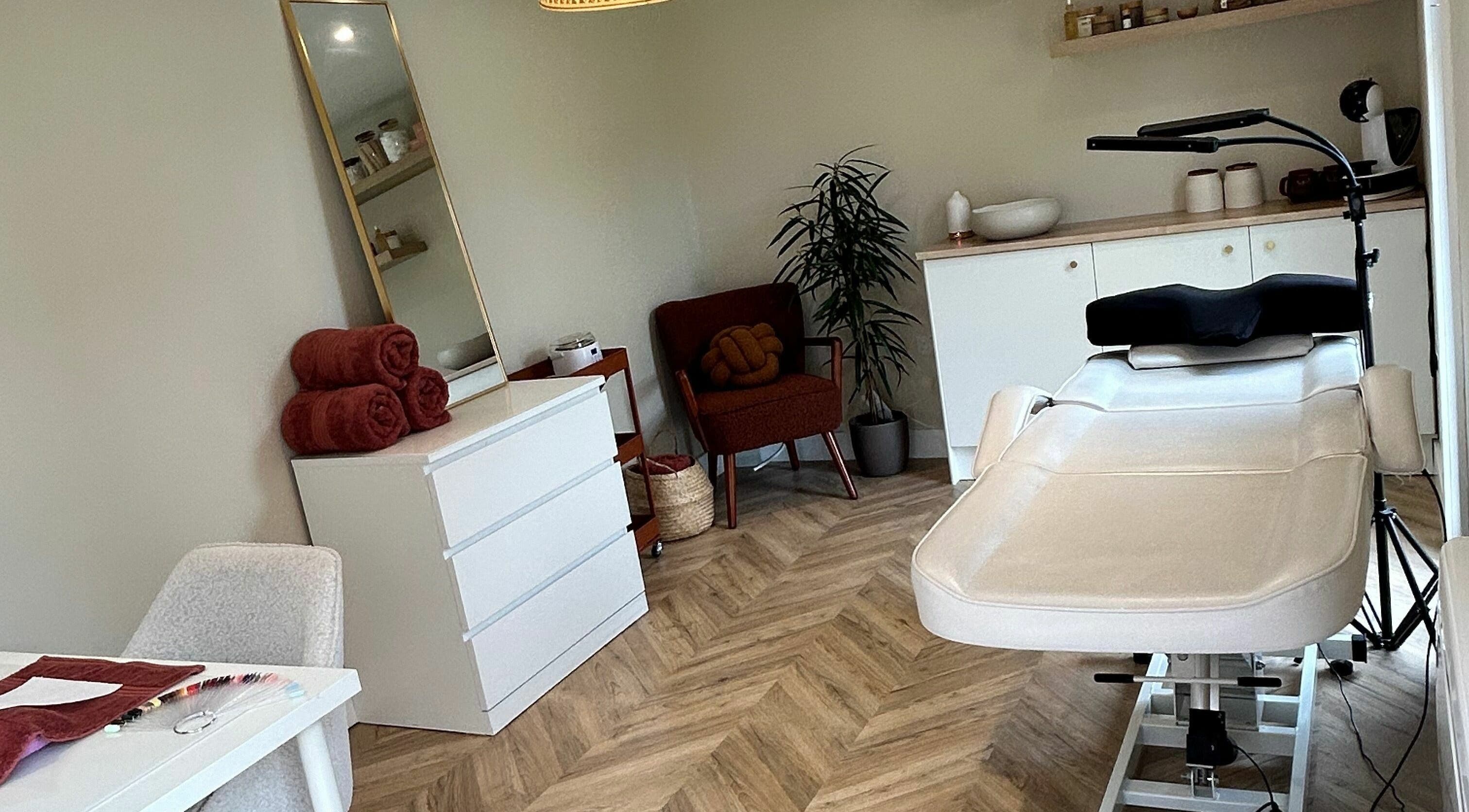 Relaxing treatment room at Beauty at Bullrush, Standish, England, GB, featuring a white therapy bed and cozy decor.