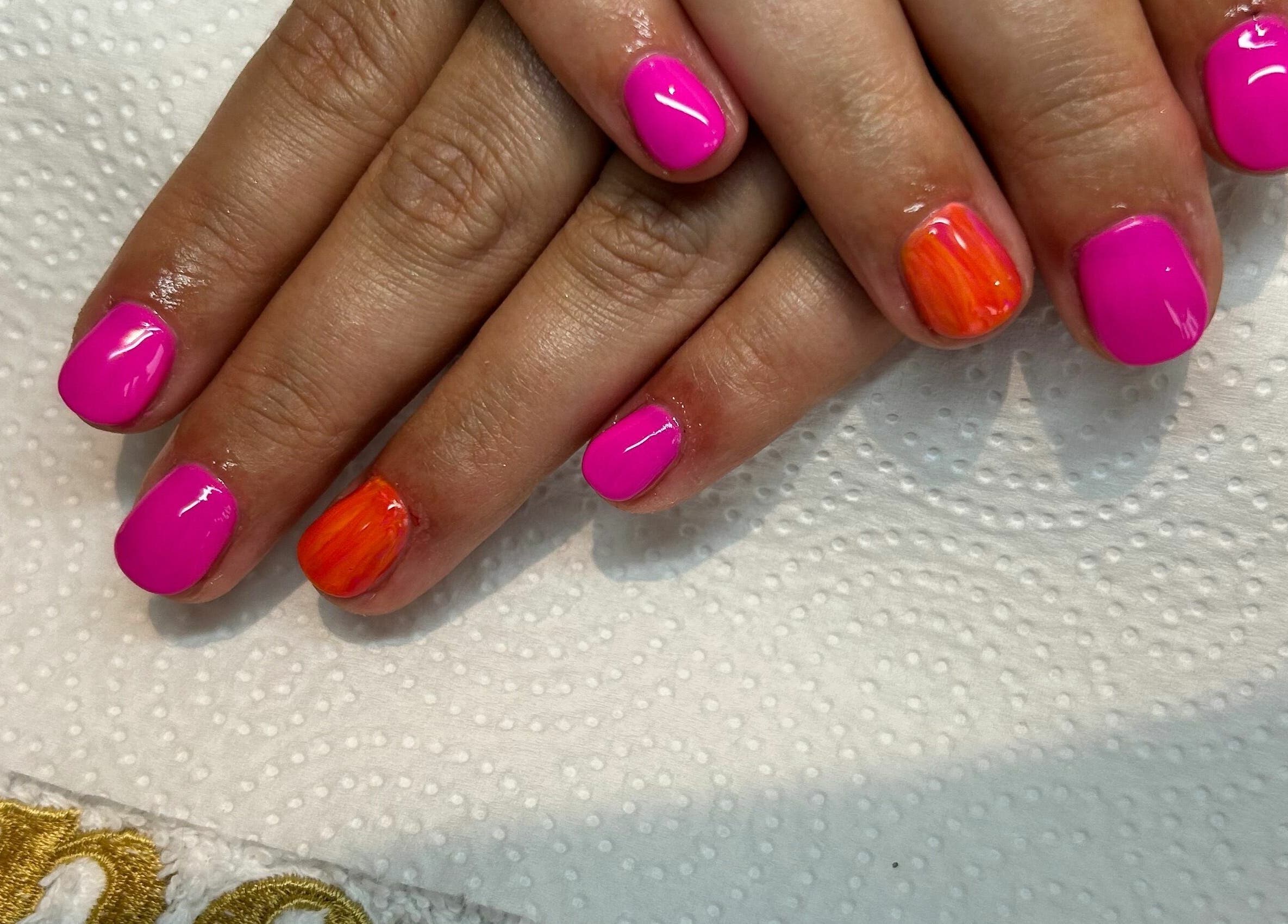 Colorful nail art at Beauty at Bullrush, Standish, England, GB. Showcasing pink and orange designs.