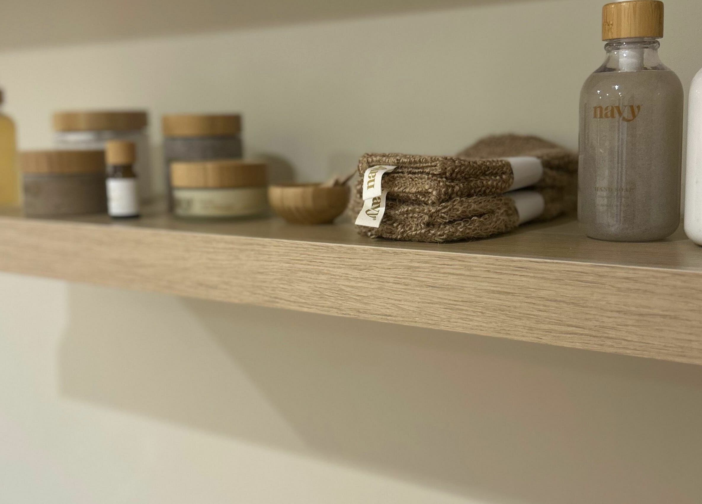 Natural skincare products on a wooden shelf at Beauty at Bullrush, Standish, England, GB.