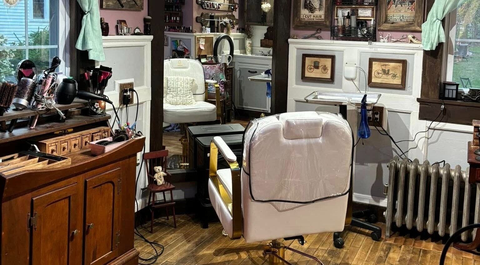 Interior of Jennifa Styles Hair Salon & Lounge in West Brookfield, MA, featuring elegant styling chairs and decor.