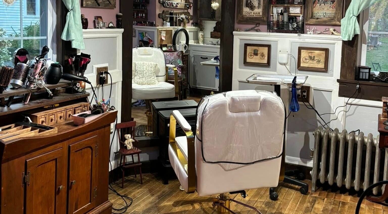 Interior of Jennifa Styles Hair Salon & Lounge in West Brookfield, MA, featuring elegant styling chairs and decor.