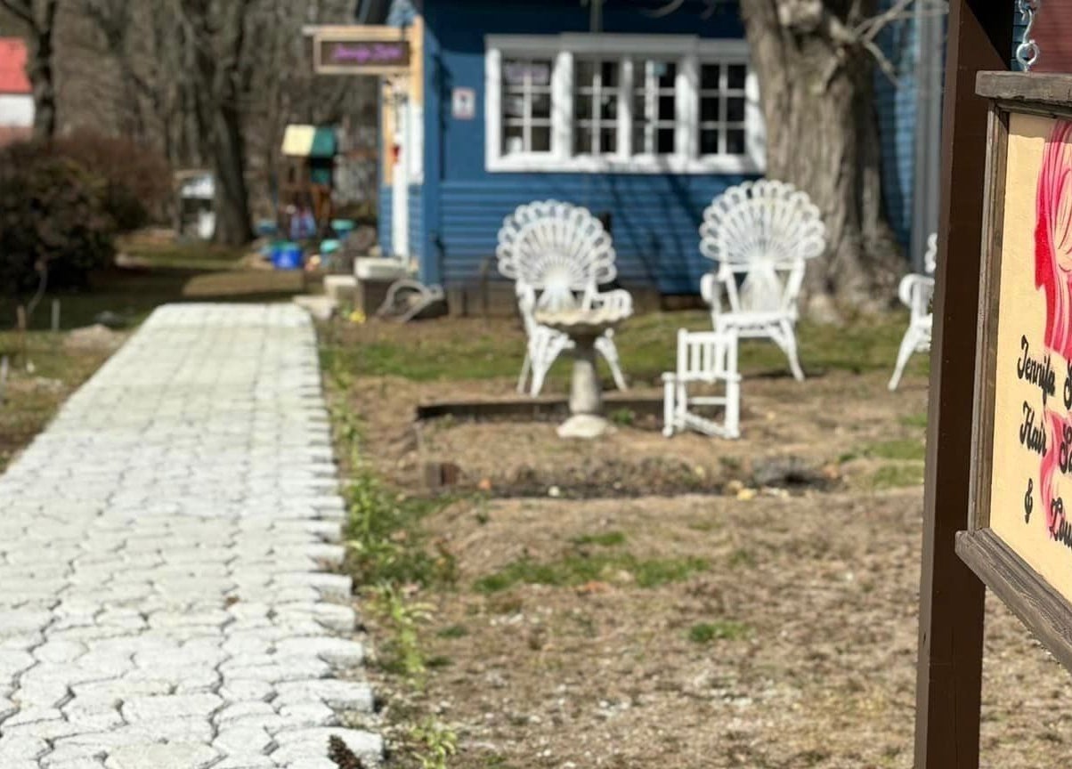 Charming path leading to Jennifa Styles Hair Salon & Lounge in West Brookfield, Massachusetts, US, with cozy outdoor seating.