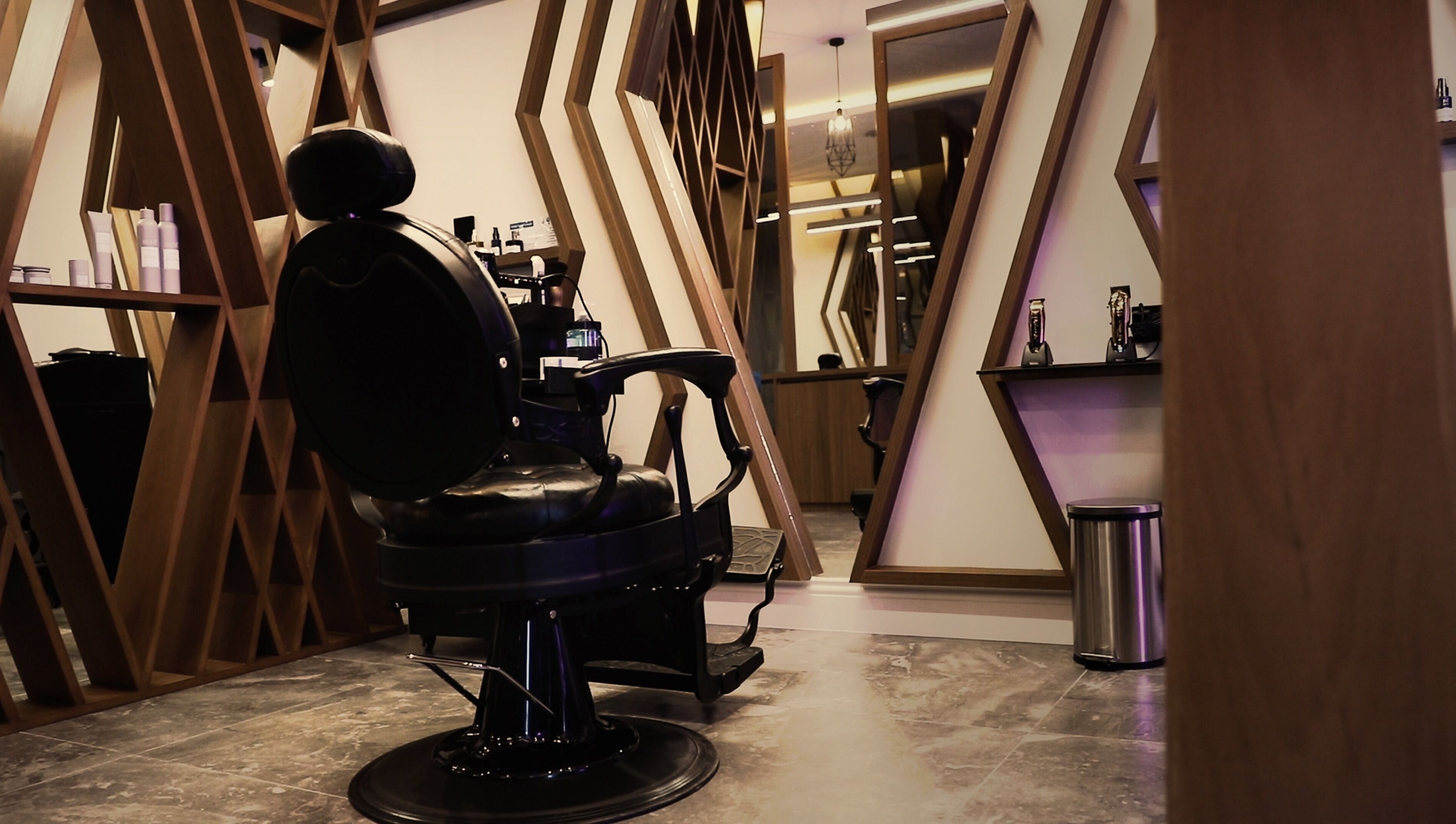 Luxury barber chair at Dapper Barbershop, Dhahran, Eastern Province, SA with stylish decor and mirrors.