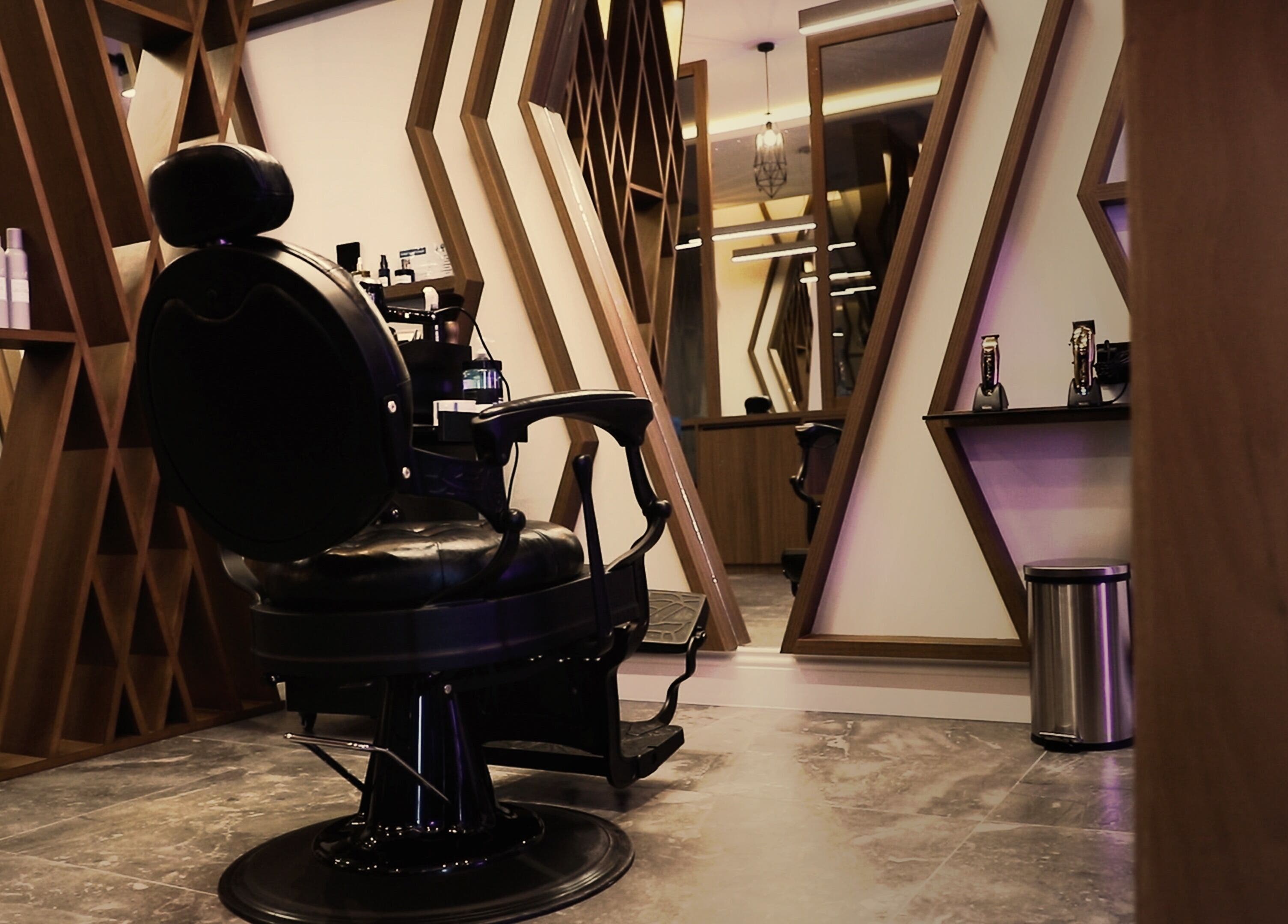 Luxury barber chair at Dapper Barbershop, Dhahran, Eastern Province, SA with stylish decor and mirrors.