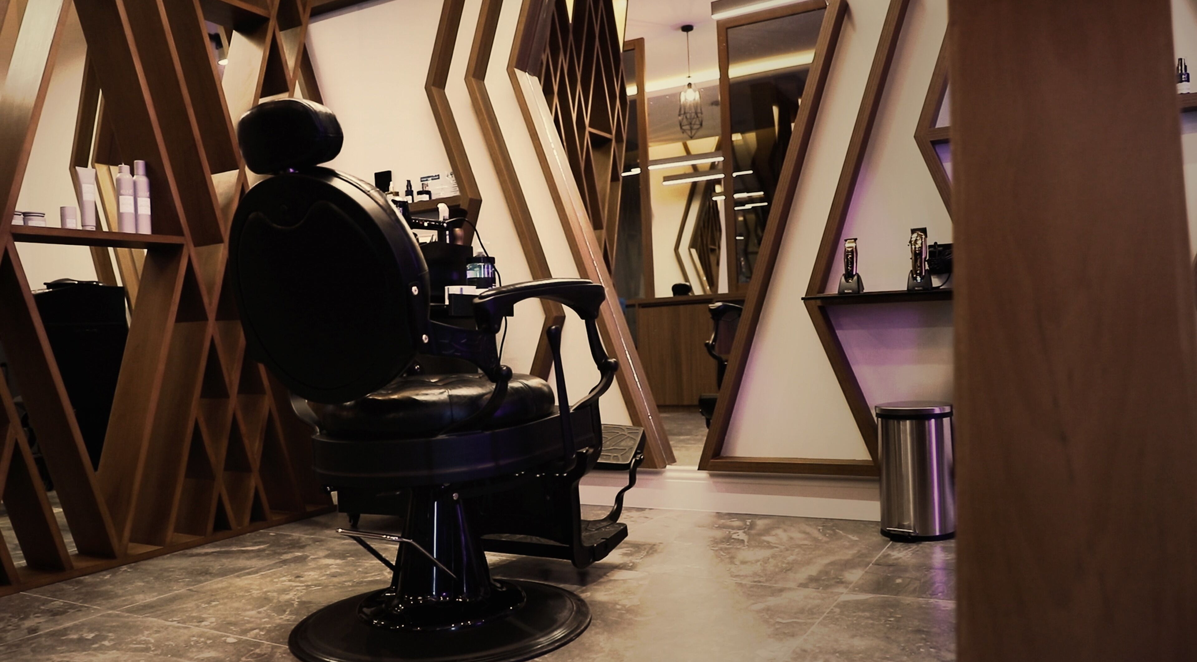 Luxury barber chair at Dapper Barbershop, Dhahran, Eastern Province, SA with stylish decor and mirrors.