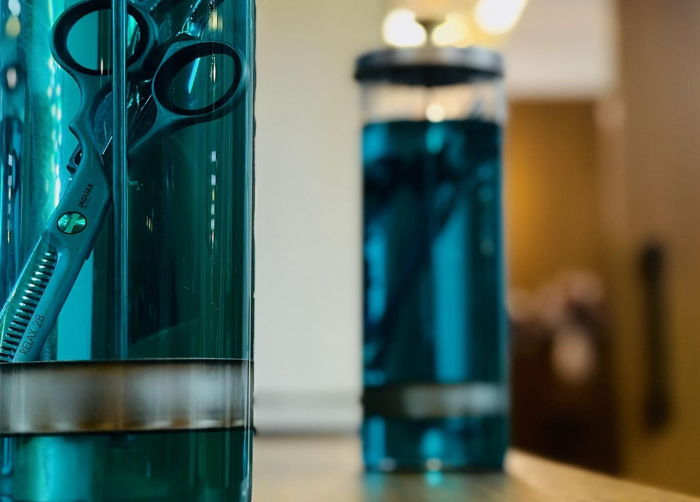 Barber scissors in sterilizing jar at Dapper Barbershop, Dhahran, Eastern Province, SA.