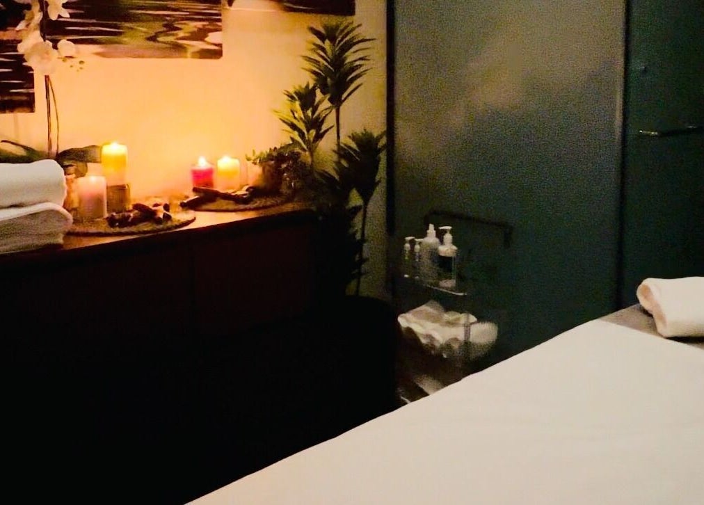 Relaxing spa room at Dapper Barbershop, Dhahran, Eastern Province, SA with candles and fresh towels.