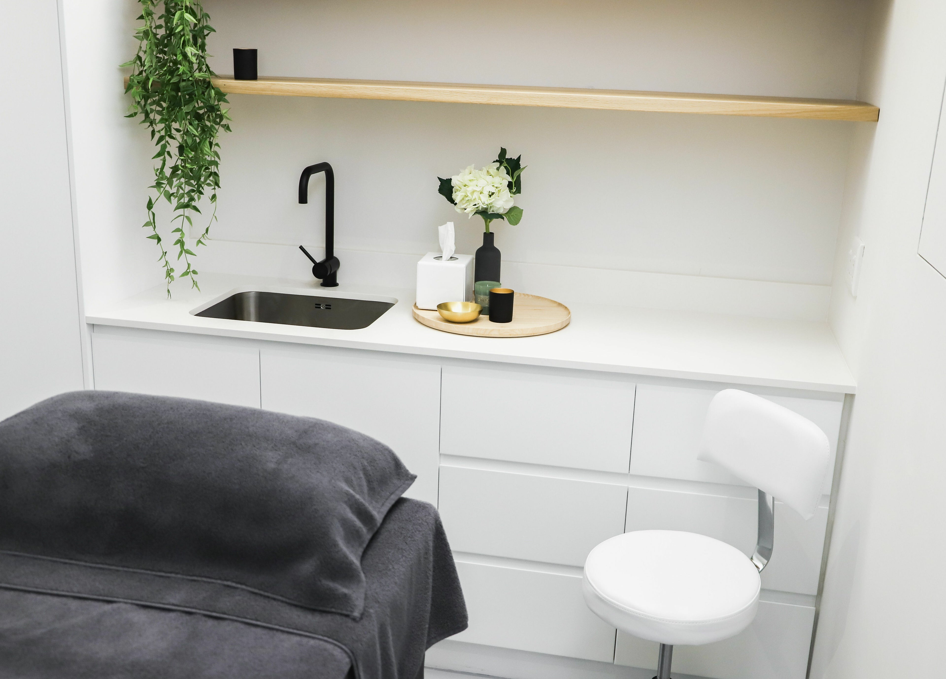 Elegant treatment room at Meraki Aesthetics, Cape Town, Western Cape, ZA with modern decor and cozy ambiance.