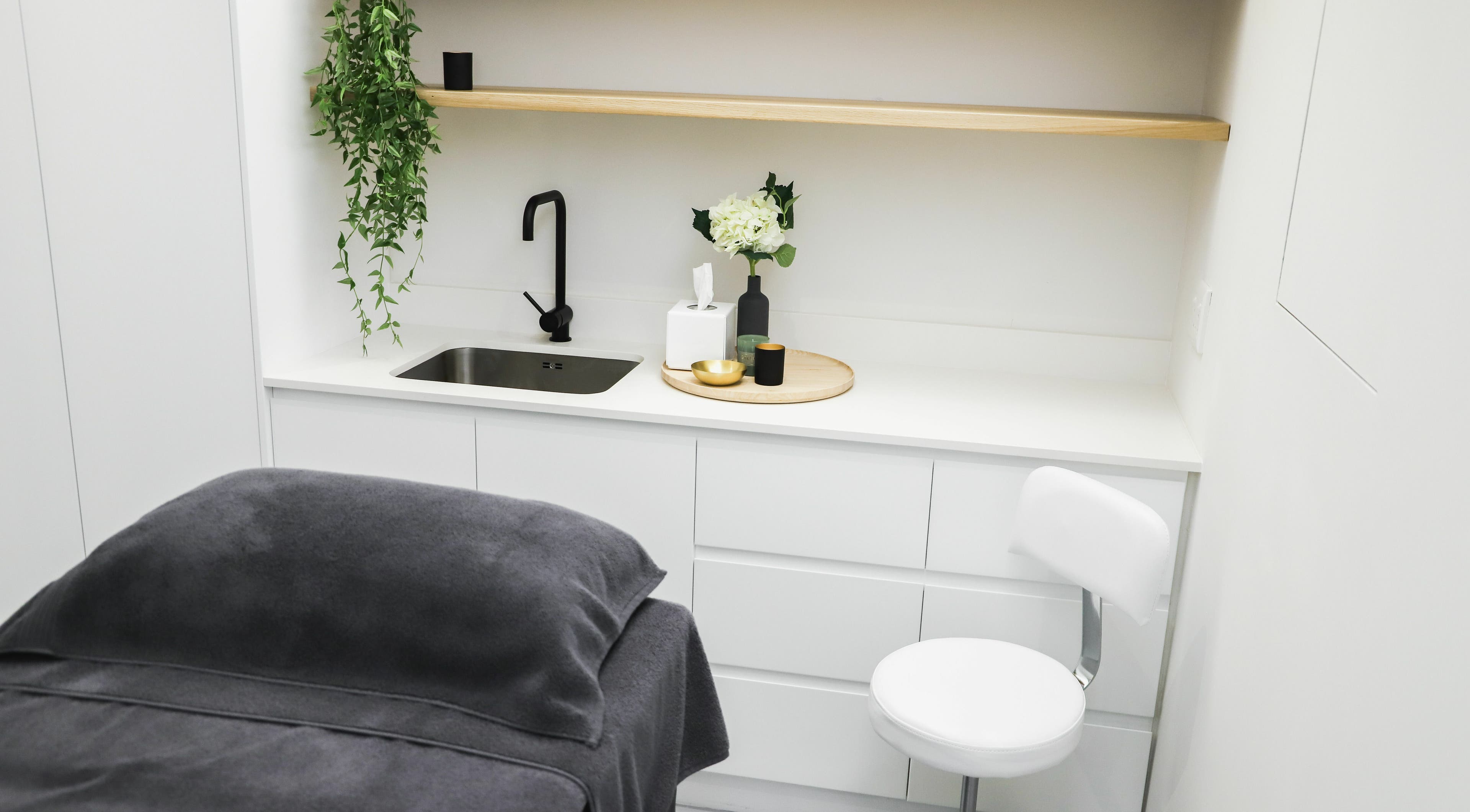 Elegant treatment room at Meraki Aesthetics, Cape Town, Western Cape, ZA with modern decor and cozy ambiance.