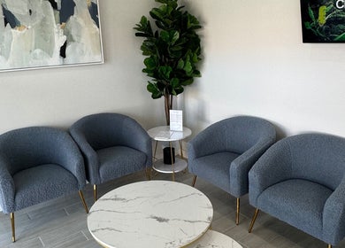 Chic seating area at Live Well Aesthetics in Nassau, New Providence, BS with stylish chairs and decor.