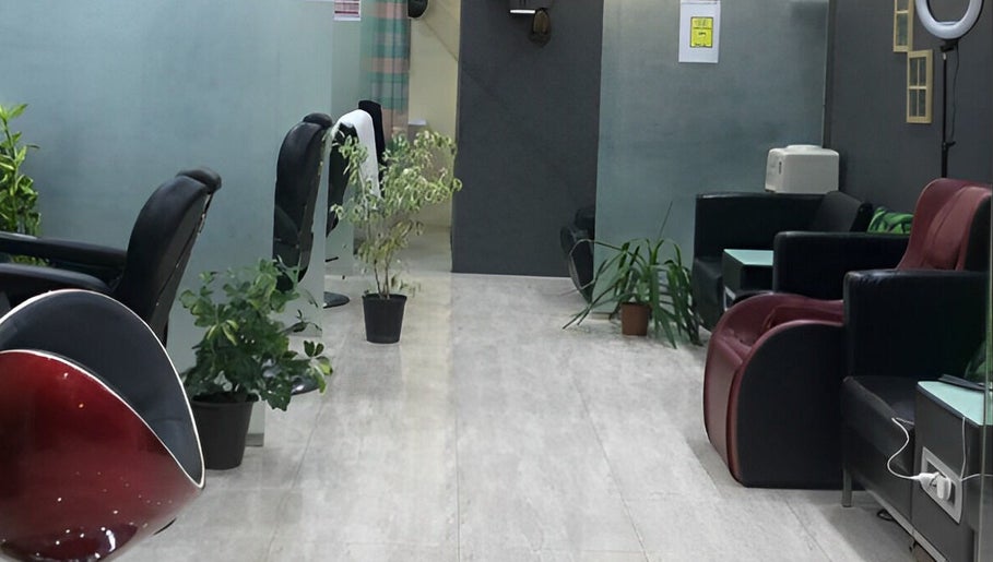 Interior of Al Lord Barber Shop, Muscat, showcasing sleek chairs and greenery for a relaxing ambiance.