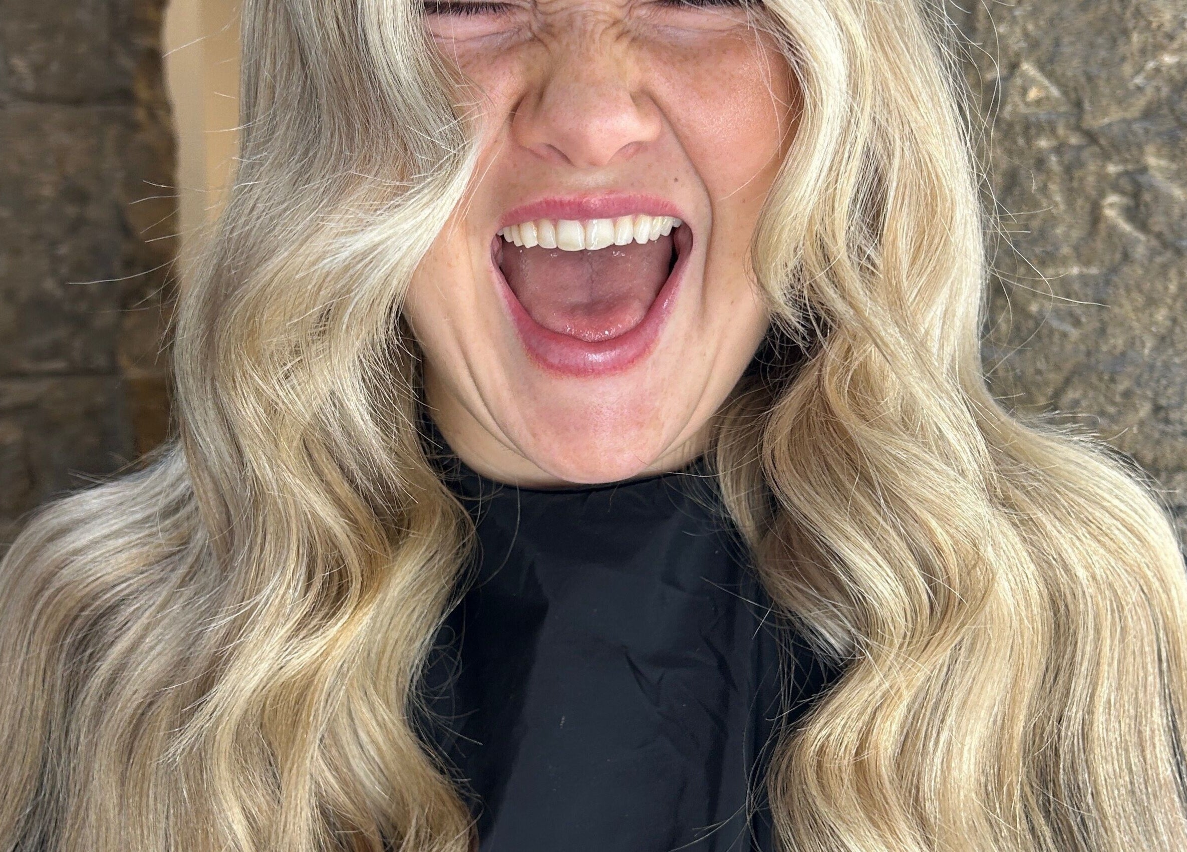 Smiling blond woman with wavy hair at Blondes & Brondes By Beth, East Kilbride, Scotland, GB.