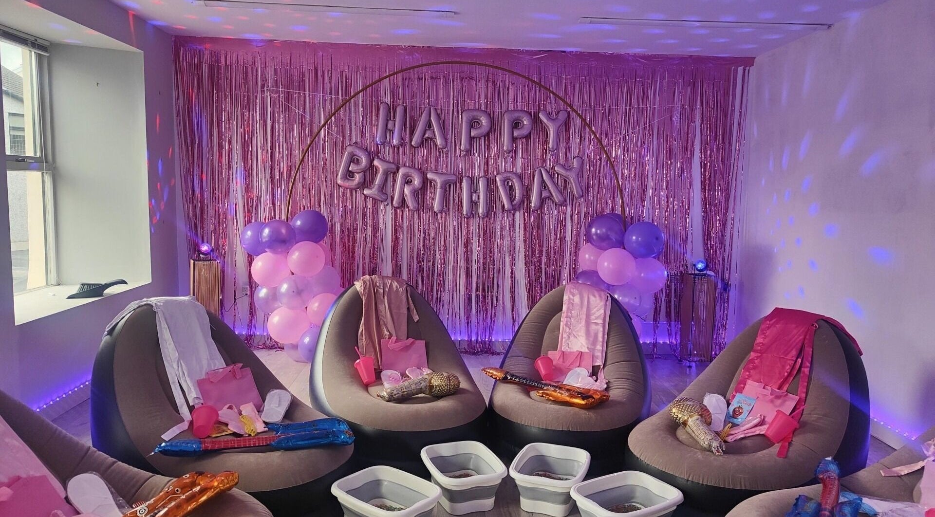 Birthday party setup at Oh La Lash and Beauty, Llanelli, Wales, GB with chic chairs and festive decor.