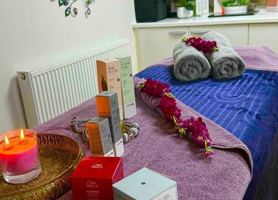 Tranquil massage room at Sawan Thai Massage Halifax, England, GB with candles and neatly arranged towels.
