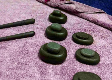 Massage stones and tools on purple towel at Sawan Thai Massage Halifax, Halifax, England, GB.