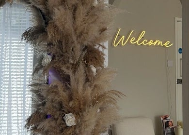 Welcome sign with pampas and flowers at By Tia Maria Beauty @ The Filler Club, Farnborough, England, GB.