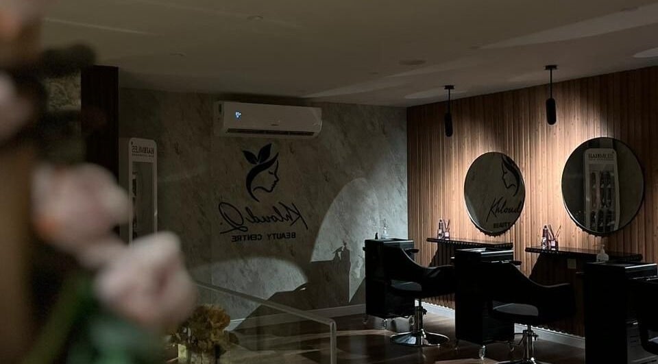 Modern salon interior at Kholoud Beauty Women’s Center, Dammam, Eastern Province, SA with mirrors and stylist chairs.