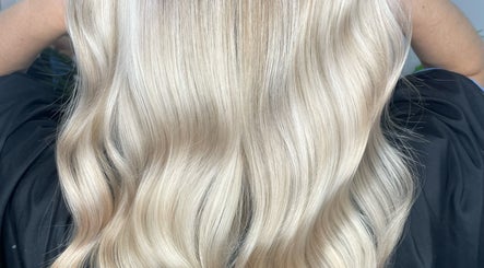 Flowing blonde hair styled at HG Studioz, South England, GB, showcasing a smooth and shiny finish.