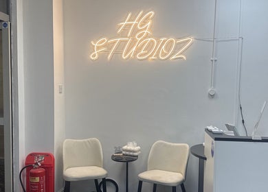 HG Studioz reception area with seating and neon sign in South, England, GB.