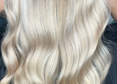 Silky blonde hair styled in waves at HG Studioz in South England, GB, showcasing expert coloring service.