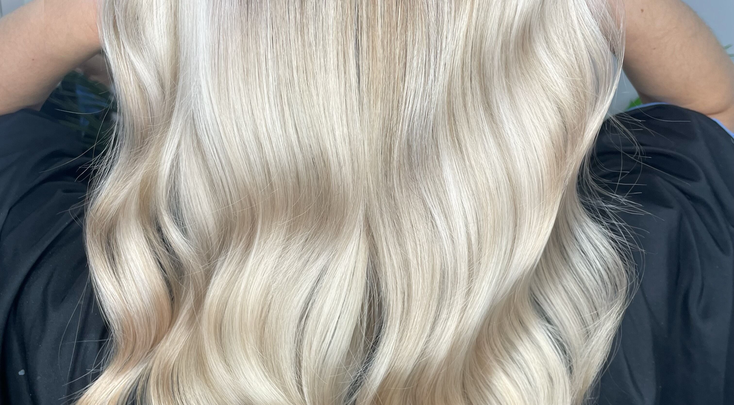 Silky blonde hair styled in waves at HG Studioz in South England, GB, showcasing expert coloring service.