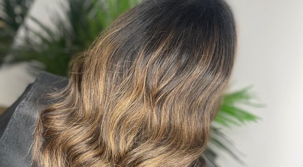 Stylish wavy brown hair at HG Studioz, South, England, GB, styled with precision amidst a serene backdrop.