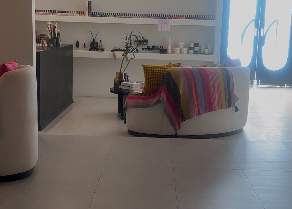 Stylish lounge area at NAILAX | نيلاكس, Riyadh, Riyadh Province, SA, featuring cozy seating and colorful decor.