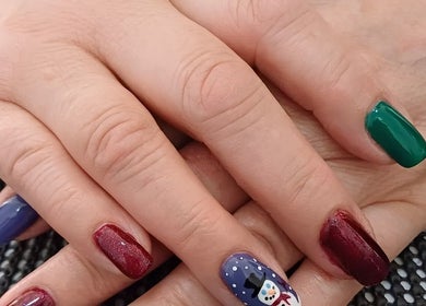 Colorful festive manicure at Beauty by Merle, Randburg, Gauteng, ZA, featuring snowman nail art.