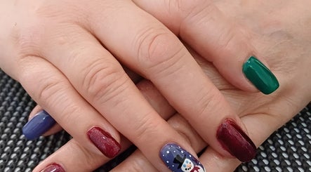 Colorful festive manicure at Beauty by Merle, Randburg, Gauteng, ZA, featuring snowman nail art.