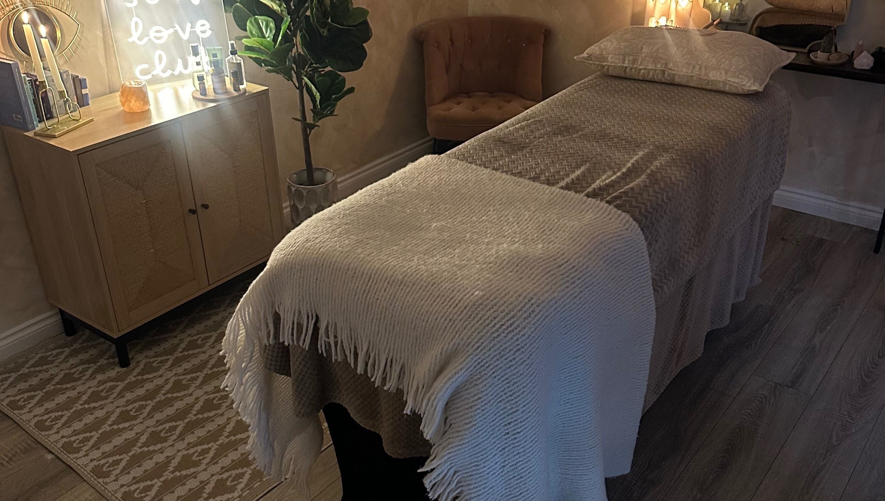Serenity Seven treatment room in Hamilton, Scotland with a massage table and soft lighting.