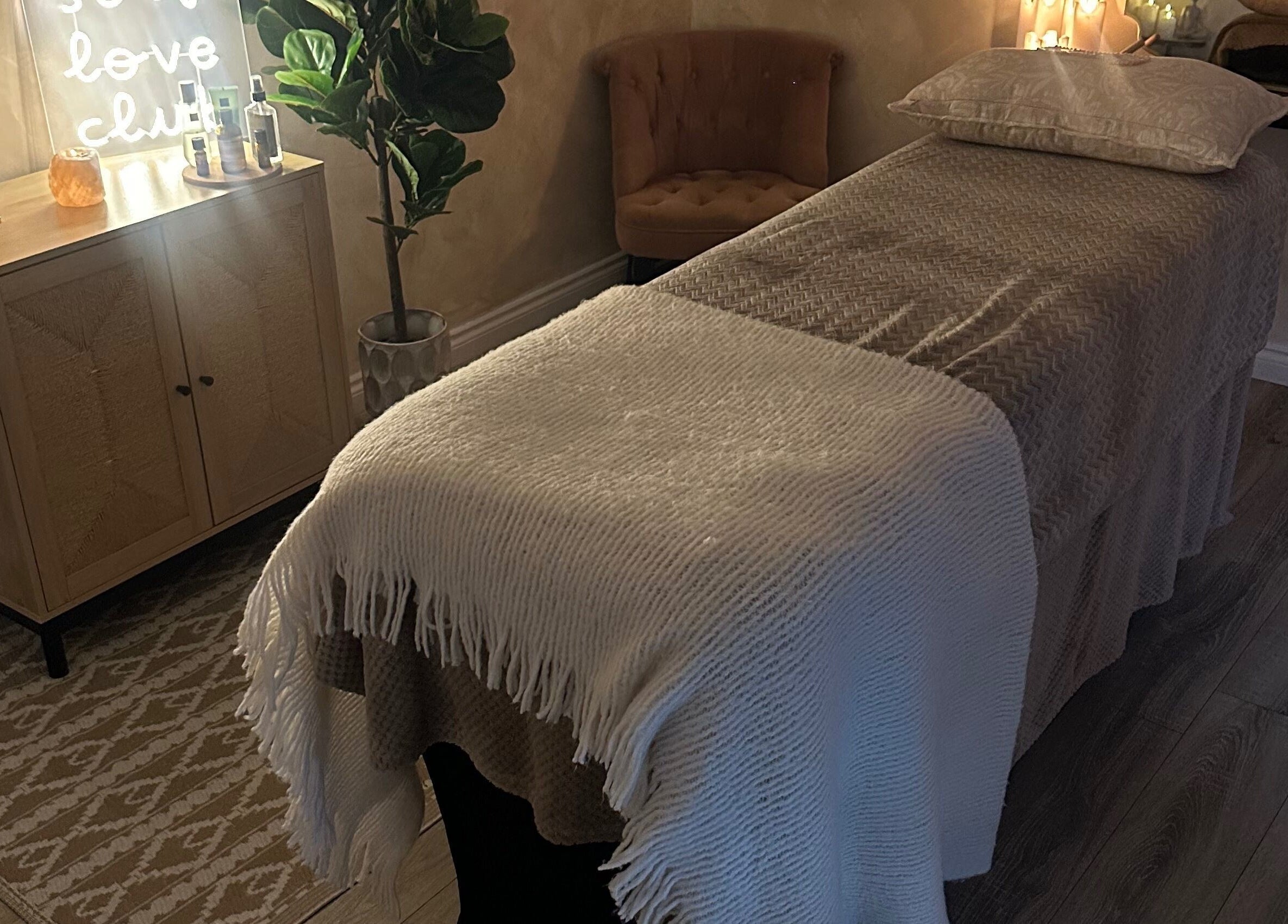 Serenity Seven treatment room in Hamilton, Scotland with a massage table and soft lighting.