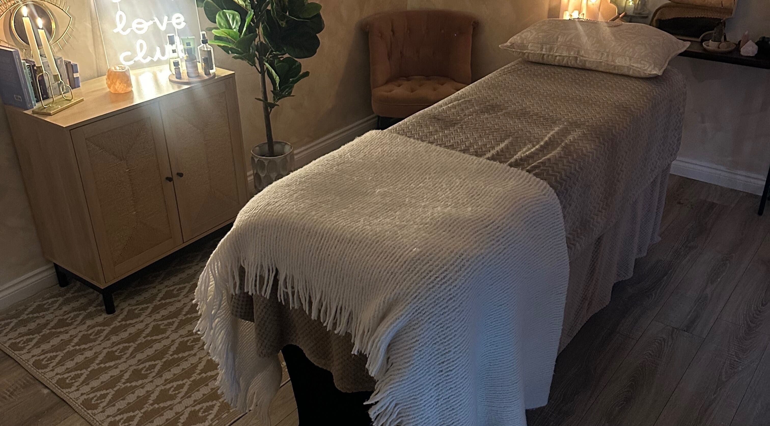 Serenity Seven treatment room in Hamilton, Scotland with a massage table and soft lighting.
