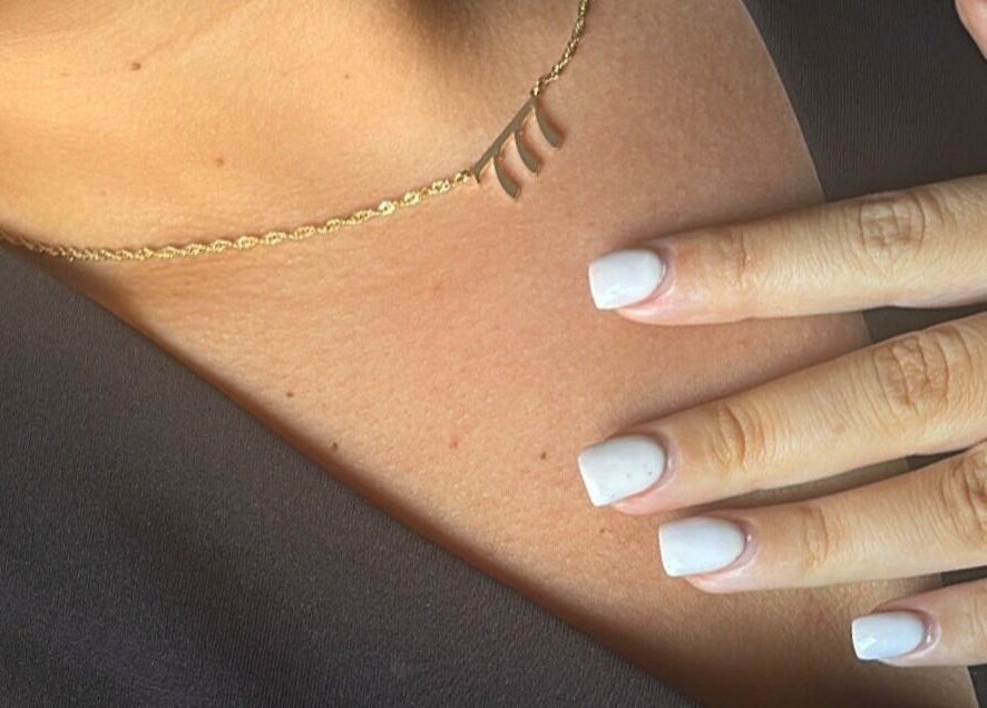 Close-up of manicured nails and gold necklace at Serenity Seven, Hamilton, Scotland, GB.