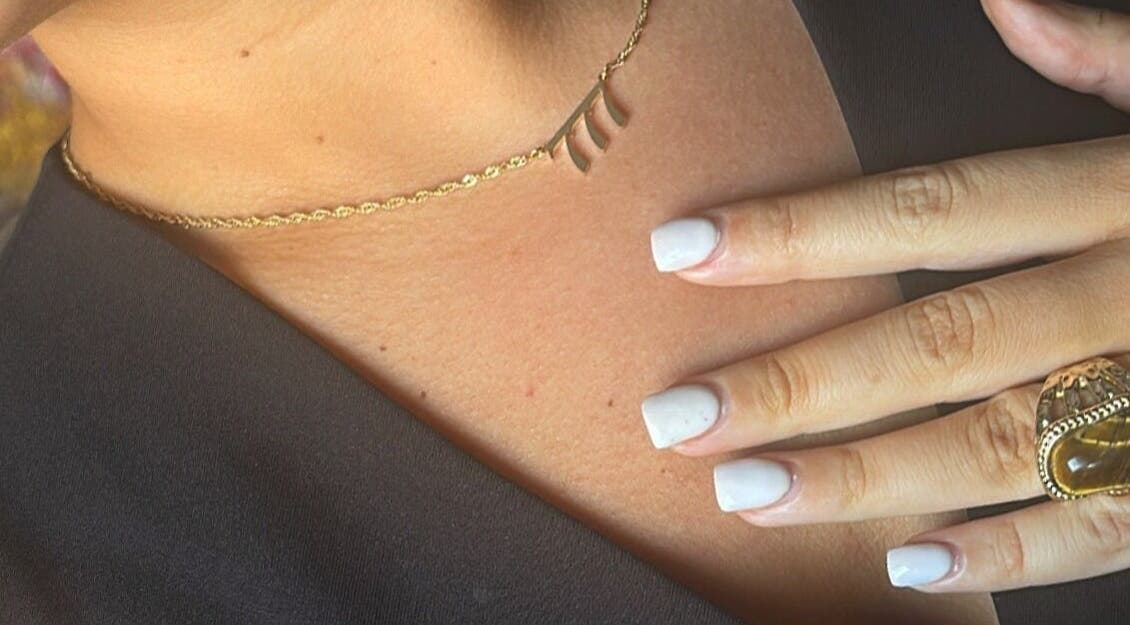 Close-up of manicured nails and gold necklace at Serenity Seven, Hamilton, Scotland, GB.