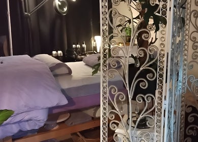 Luxury massage room at Tranquility in Hastings, England, GB featuring a cozy bed and elegant decor.